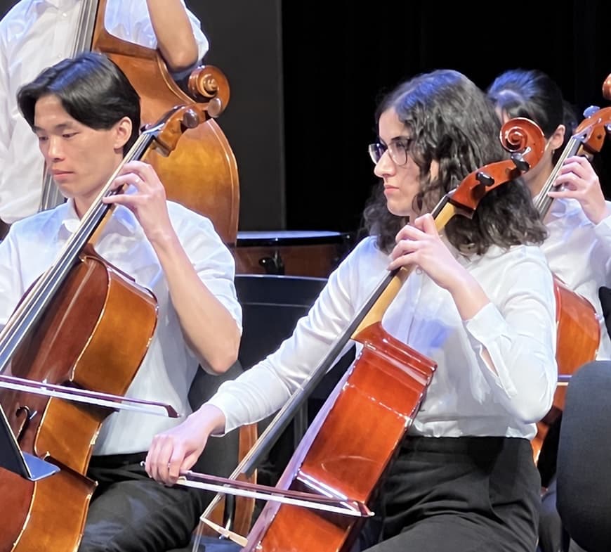 Dorsa playing cello during an orchestra rehearsal